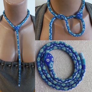 May include: A beaded snake necklace with a blue and white pattern. The necklace is shown in three different ways: as a choker, as a long necklace, and as a coiled snake.