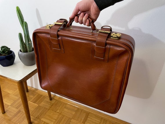 A Large Vintage Tan Leather Suitcase With Chrome Studs