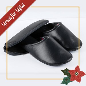 May include: A pair of black leather slippers with a zippered pouch. The slippers have a soft lining and are great for gifts.