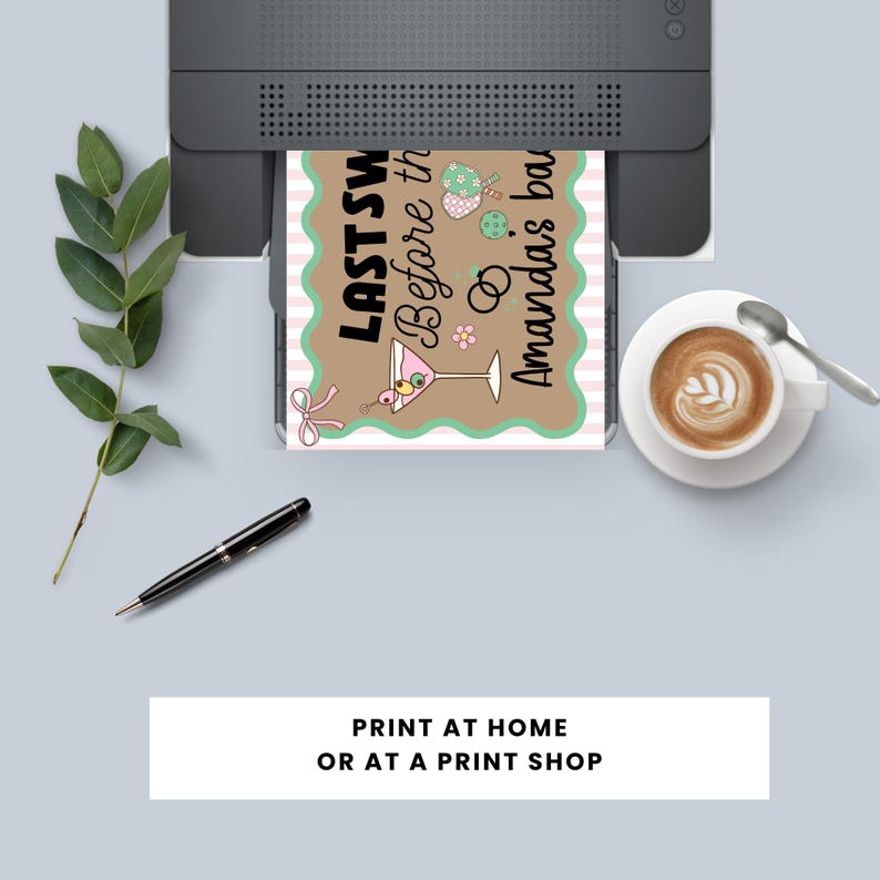 May include: A printed invitation card with the text "LAST SW Before the Amanda's bar" is emerging from a printer. The card has a brown background with a pink and white striped border and a martini glass illustration. A cup of coffee and a pen are also visible.