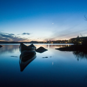 Peace, a canoe on lac Etchemin at night and his village at the end of the day in the beginning of winter Chaudière-Appalaches
