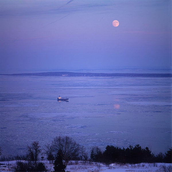 St-Lawrence River in the ice, Île aux Lièvres, cargo and moon from Saint-Siméon