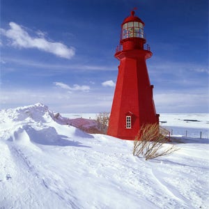 Lighthouse of la Martre in winter and ice cover on Saint-Lawrence, Gaspe Coast