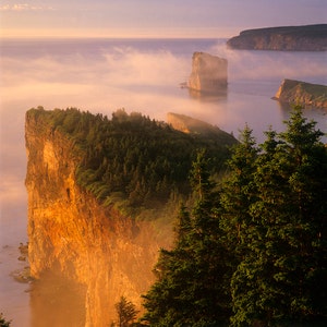 First light on morning fog, Percé Rock, the Three Sisters, the Cap Mont-Joli and the Bonaventure Island.