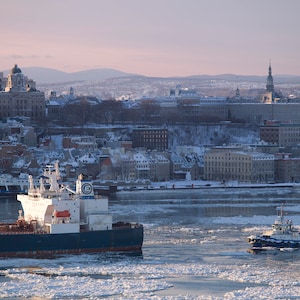 Boats and tug on the  ice of the Saint-Lawrence River  in front of Quebec city