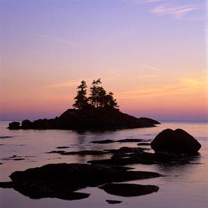 First ligt on rocks and a small island of Pointe-Mitis at Métis-sur-Mer, Gaspe Coast