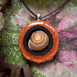 May include: A set of three ceramic mugs with a speckled, matte finish. The mugs are in shades of cream, light gray, and dark gray. Each mug has a simple, minimalist design, perfect for coffee or tea.