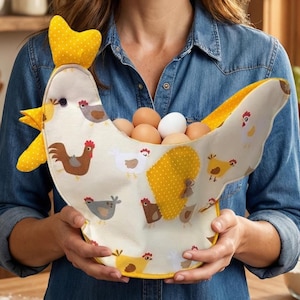 May include: A whimsical, cream-colored chicken-shaped egg basket with yellow polka-dot accents. The basket is filled with brown and white eggs and decorated with various chicken illustrations. The basket has a yellow comb and wattle, and is being held by a person wearing a denim shirt.