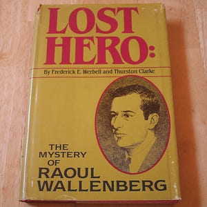 May include: A yellow book cover with the title "Lost Hero: The Mystery of Raoul Wallenberg" in black text. The book cover also features a black and white illustration of a man's face.