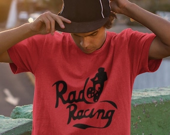 May include: A red t-shirt with a black graphic of a person riding a bicycle and the text "Rad Racing".