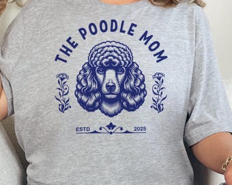 May include: Gray t-shirt with a blue graphic of a poodle and the text "The Poodle Mom" with "Est. 2025" below.