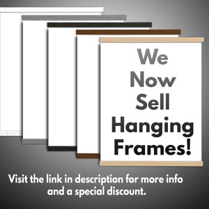 May include: A display of hanging frames with various wood finishes, including white, gray, dark green, brown, and natural wood. The frames hold white paper and the text "We Now Sell Hanging Frames!" is displayed on one of the frames.