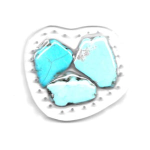 May include: Three turquoise stones of varying sizes and shapes, set in a white heart-shaped frame.