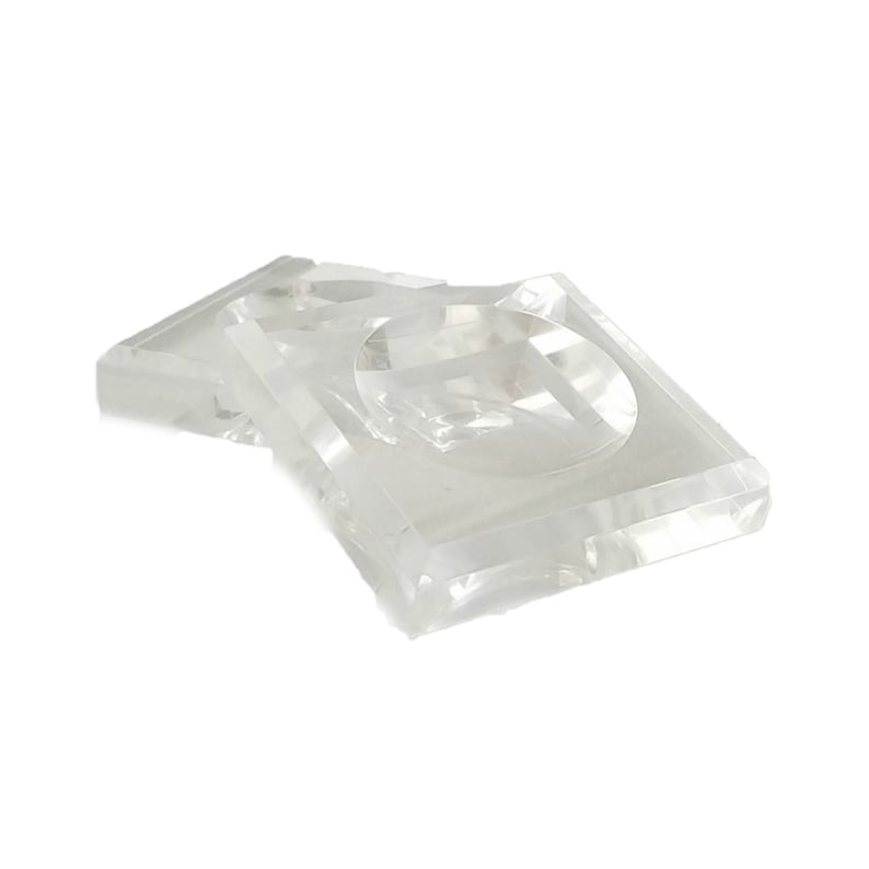 May include: Two clear plastic square-shaped display stands with a circular indentation in the center.