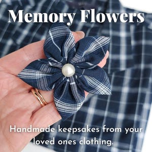 May include: A blue and white checked fabric flower with a pearl centre. "Memory Flowers" and "Handmade keepsakes from your loved ones clothing." are written in white text on a blue and white checked background.