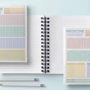 May include: Two spiral bound notebooks with lined pages and a medicine tracker page. The medicine tracker page has sections for name, time, and days of the week. The notebook covers are white with black spiral binding.