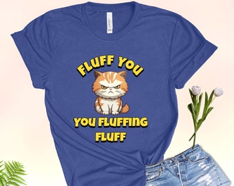Puede incluir: Una camiseta azul real con un gato de dibujos animados y el texto "Fluff You You Fluffing Fluff" en amarillo.
