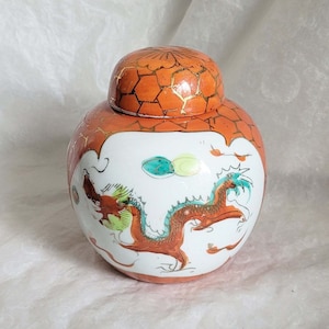 Attractive floral ginger jar from China, decorated with an orange, gold, teal, green and white hand painted dragon-13cm tall