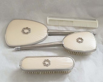 Vintage 4 piece silver metal vanity set, decorated with an attractive floral marcasite centre piece, mirror, hairbrush, clothes brush & comb