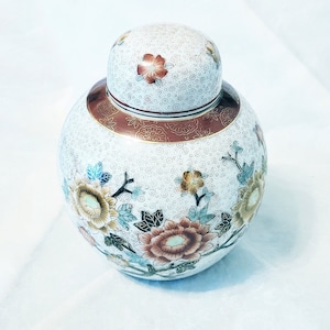 Attractive floral ginger jar from China, decorated with an orange, green, gold and white hand painted floral design
