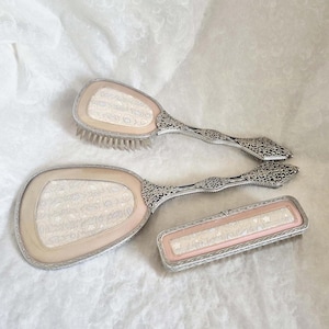Vintage 3 piece silver vanity set, embellished with an attractive pink, blue and silver embroidered floral pattern, mirror and x2 brushes