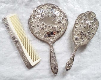 Vintage 3 piece silver plated vanity set, embellished with an attractive floral butterfly design, mirror, comb and brush
