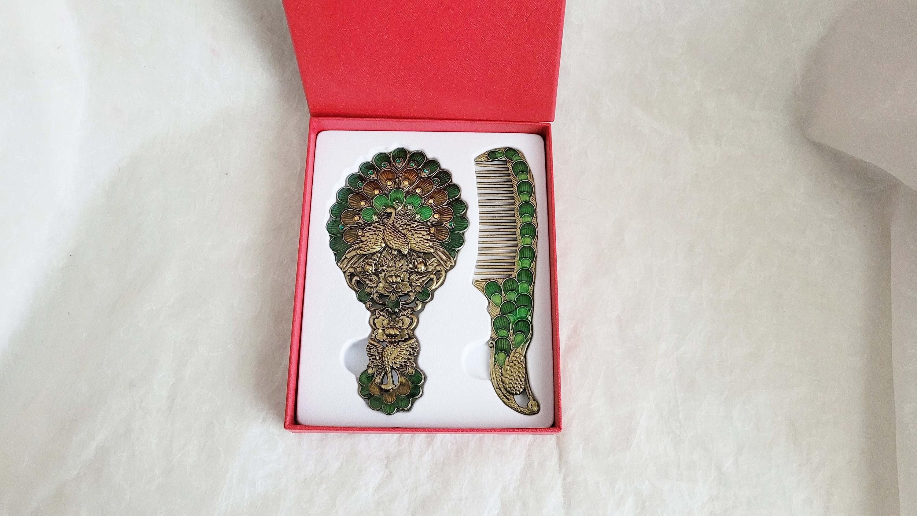 Boxed vintage style enamelled hand mirror and comb, intricate green, copper and brass Peacock diamanté patterned fascia-13cm long