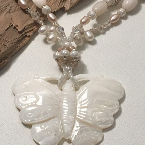 Carved Mother of Pearl Butterfly Pendant with Beaded Beads, Swarovski Crystals, and Freshwater Pearls. Sterling Silver Closure.