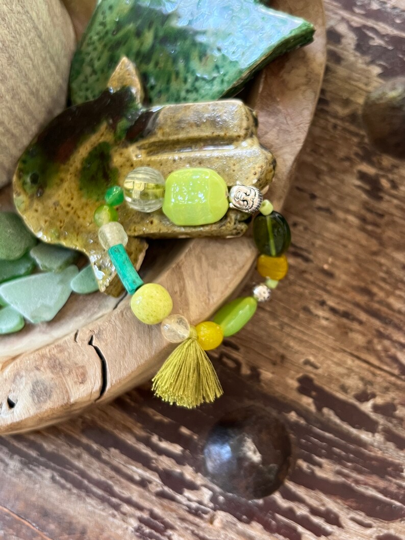 Bracelet in multi-colored African glass beads, agate, gorgon, Tibetan silver bead and green pompom. image 1