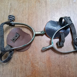 Antique boot spurs with leather straps