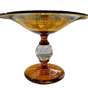 May include: A clear glass bowl with a brown rim and a clear glass base with a bubbled texture. The bowl is on a white background.