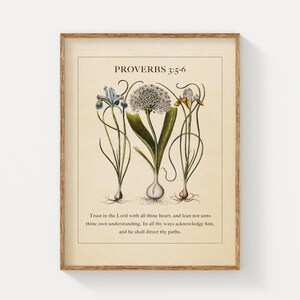 Printable featuring Proverbs 3:5-6 Bible Verse paired with illustrated vintage botanicals shown in a wood frame on a clean white wall.