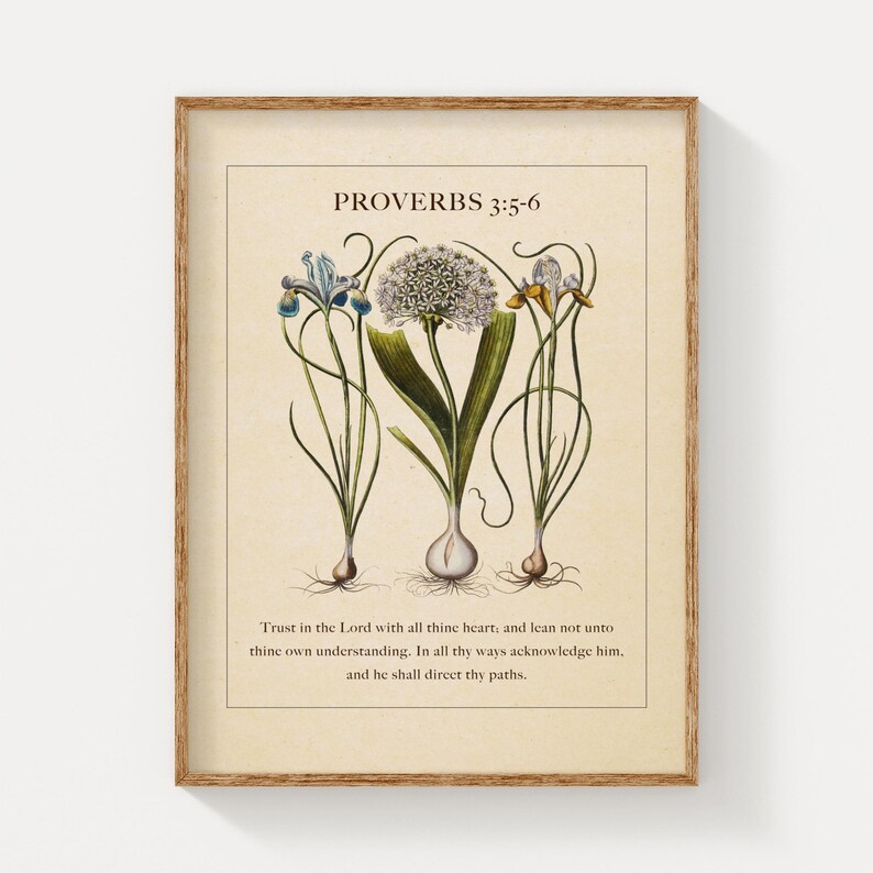 Printable featuring Proverbs 3:5-6 Bible Verse paired with illustrated vintage botanicals shown in a wood frame on a clean white wall.