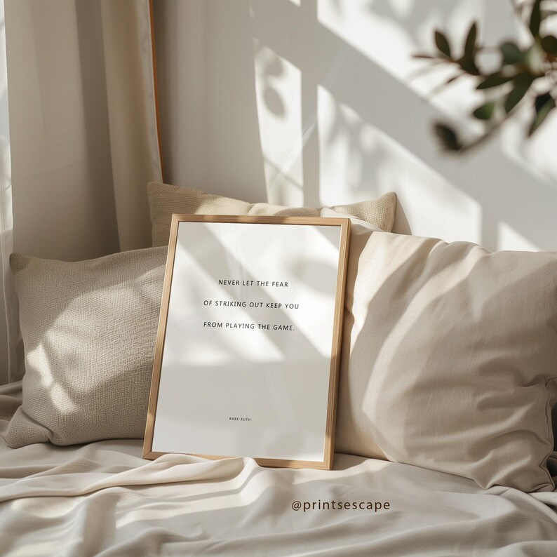 Inspirational sports quote print with simple typography, styled in a cozy bedroom with natural sunlight streaming onto neutral linens.