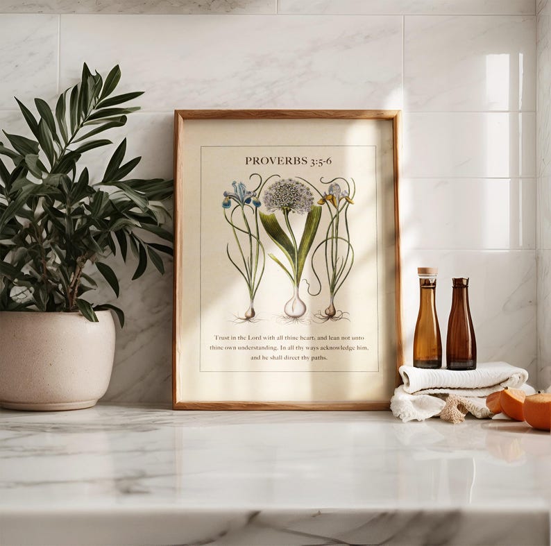 Kitchen counter showing a framed printable featuring Proverbs 3:5-6 Bible Verse paired with illustrated vintage botanicals.