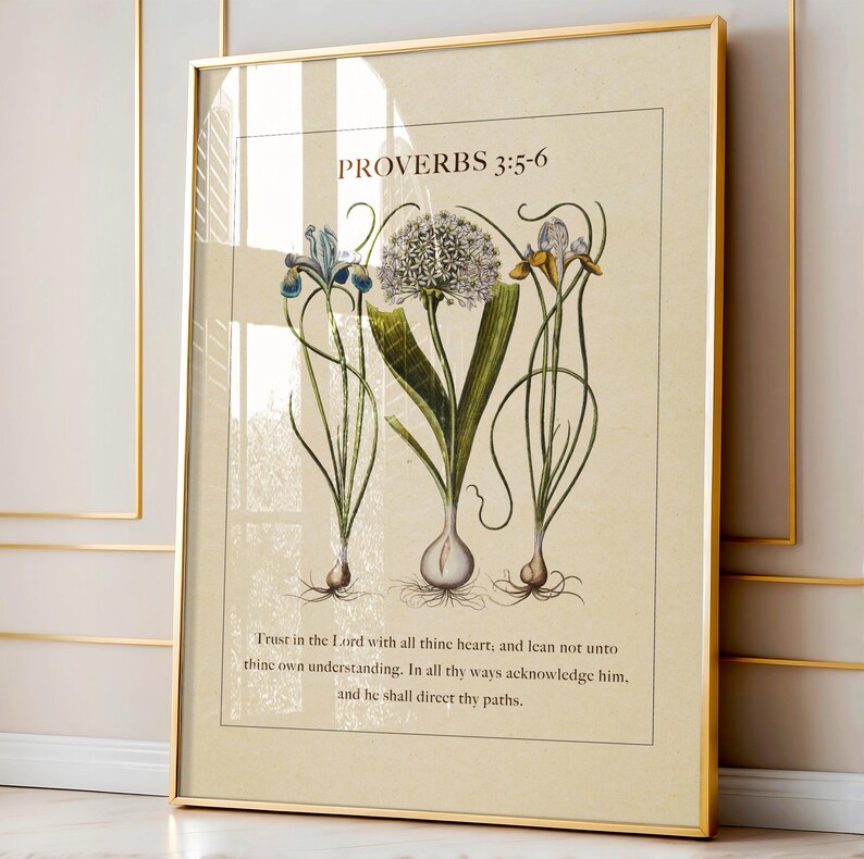 Close up of a printable featuring Proverbs 3:5-6 Bible Verse paired with illustrated vintage botanicals shown in a gold frame on a rich gold trimmed wall.
