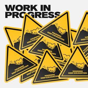 May include: A pile of yellow and black warning signs, each with the text "WARNING DEEP EXCAVATION" and a cartoon digging creature. The words "WORK IN PROGRESS" are at the top.