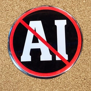 May include: A red circle with a diagonal red line through it, on a black background. The letters "AI" are in white inside the circle.