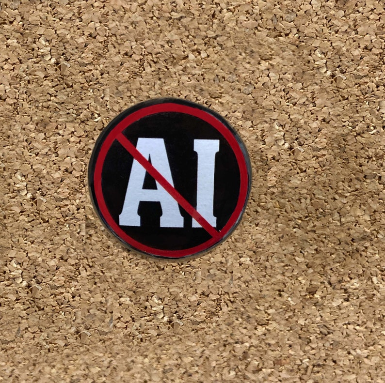 Puede incluir: Un bot&oacute;n negro y rojo con una l&iacute;nea diagonal blanca que atraviesa las letras "AI".