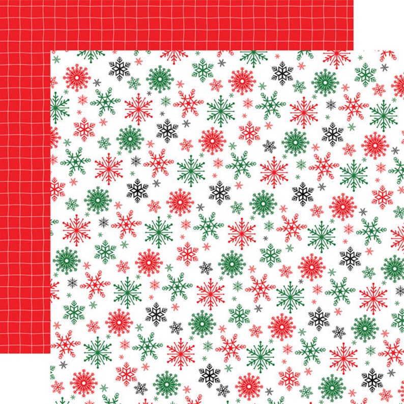 May include: A seamless pattern of red, green, and black snowflakes on a white background. The snowflakes are of varying sizes and are arranged in a random pattern.