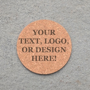 May include: A round cork coaster with the text "YOUR TEXT, LOGO, OR DESIGN HERE!" engraved on the surface.
