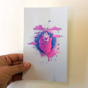 May include: A pink and blue illustration of a hand holding a square object with a flame inside. Pink clouds and blue splatter surround the hand. The artwork has a surreal, dreamlike quality.