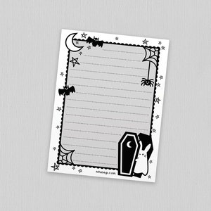 May include: Black and white printable stationery paper with a Halloween theme. The paper has a border with bats, stars, a spider web, a spider, a crescent moon, and a coffin with a bunny peeking out. The paper has gray lines for writing.