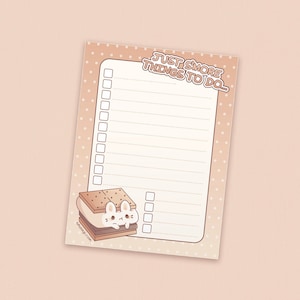 May include: A pink and white notepad with a brown and white s'more illustration and the text "Just s'more things to do..."  The notepad has a dotted pattern and a checklist with blank spaces.