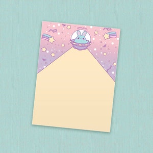May include: A light pink and purple gradient background with white stars and a light blue bunny in a spaceship. The bunny is looking to the right. The background has the text "kawaii.com" in the top right corner.