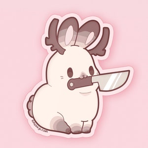 May include: A white rabbit with brown antlers and a knife in its mouth. The rabbit is wearing a pink and brown patterned shirt. The background is pink.