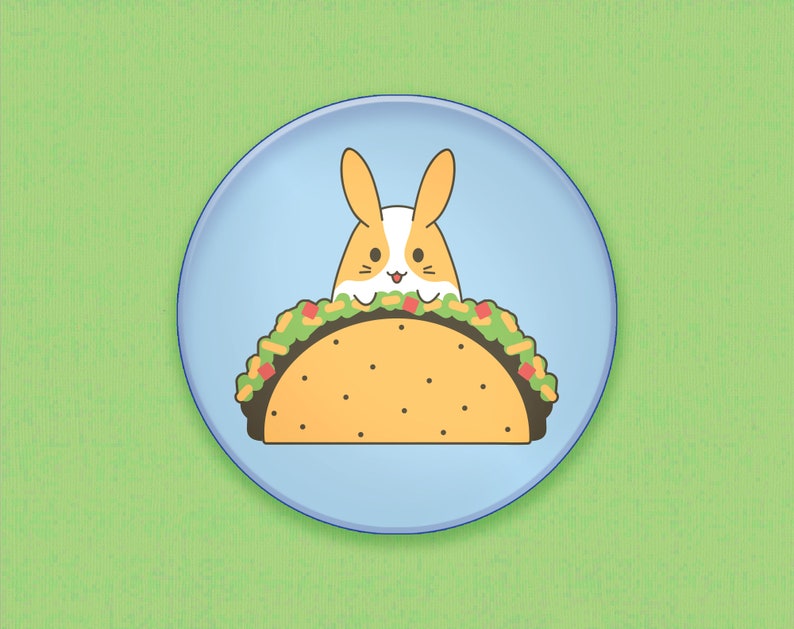 May include: A blue plate with a cartoon bunny peeking out of a taco. The taco is filled with lettuce, cheese, and meat.
