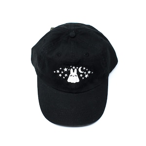 May include: Black baseball cap with a white graphic of a bunny, stars, and a crescent moon. The cap is made of a soft material and has a curved brim. The design is centered on the front of the cap.
