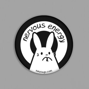 May include: Black and white sticker with a cartoon bunny and the text "nervous energy" on a white background with a black circle around it. The text "nikusagi.com" is at the bottom of the sticker.