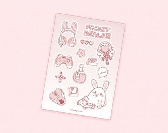 May include: A sheet of pink stickers with a pink bunny rabbit, a video game controller, a potion bottle, a heart-shaped wand, and the text "Pocket Healer".